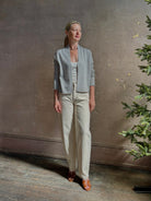 Mature woman wearing comfortable stone grey cashmere linen GUEST IN RESIDENCE Stealth long sleeve crop Cardigan with single hook and eye front closure crafted in a neutral stone grey