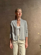 Mature woman wearing comfortable stone grey cashmere linen GUEST IN RESIDENCE Stealth long sleeve crop Cardigan with single hook and eye front closure crafted in a neutral stone grey