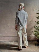 Mature woman wearing comfortable stone grey cashmere linen GUEST IN RESIDENCE Stealth long sleeve crop Cardigan with single hook and eye front closure crafted in a neutral stone grey