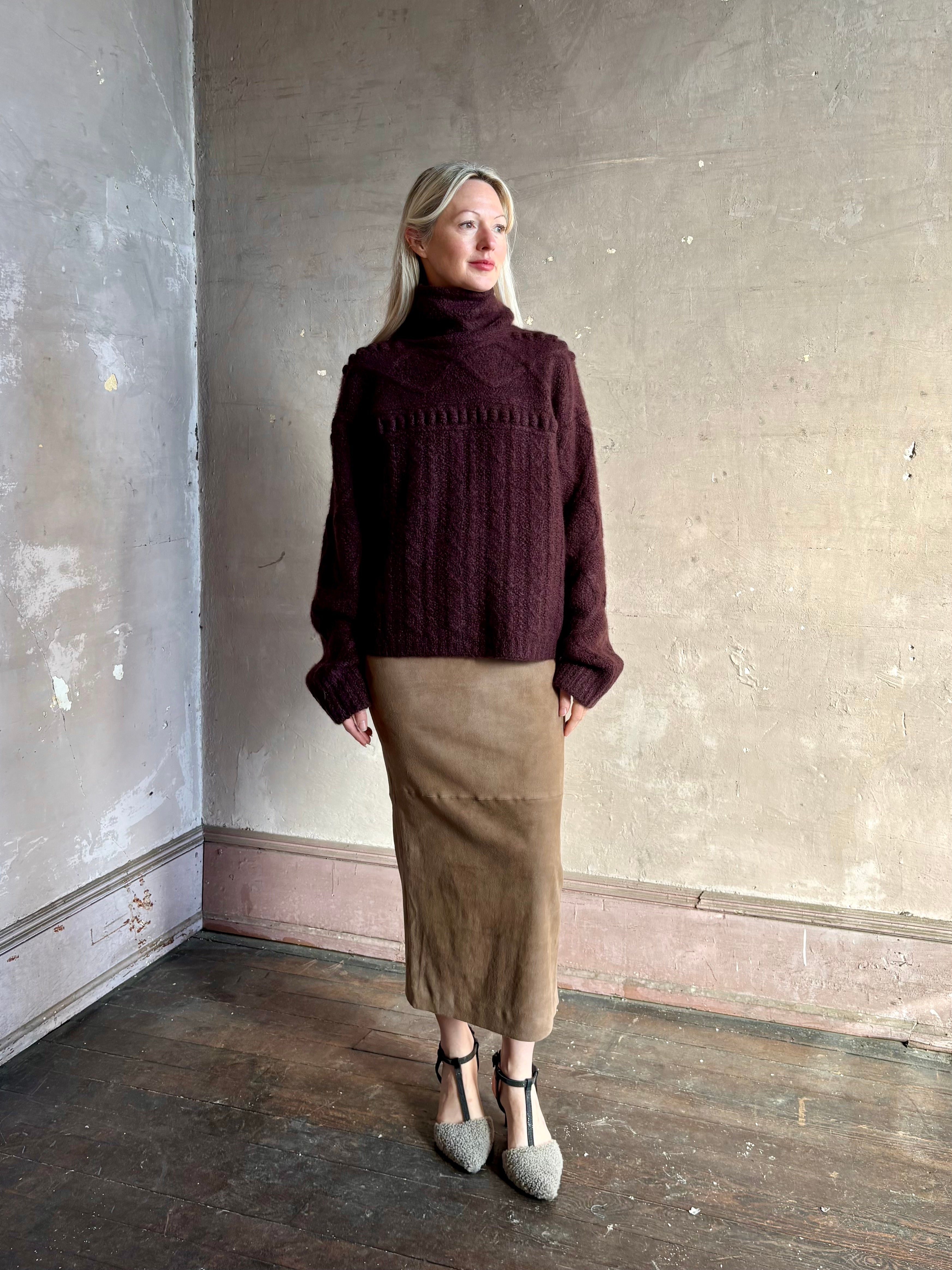 Woman wearing oversized Guest in Residence Super Cloud T Neck cashmere-silk boucle knit sweater with a cable pattern, long sleeves and funnel neck in fig