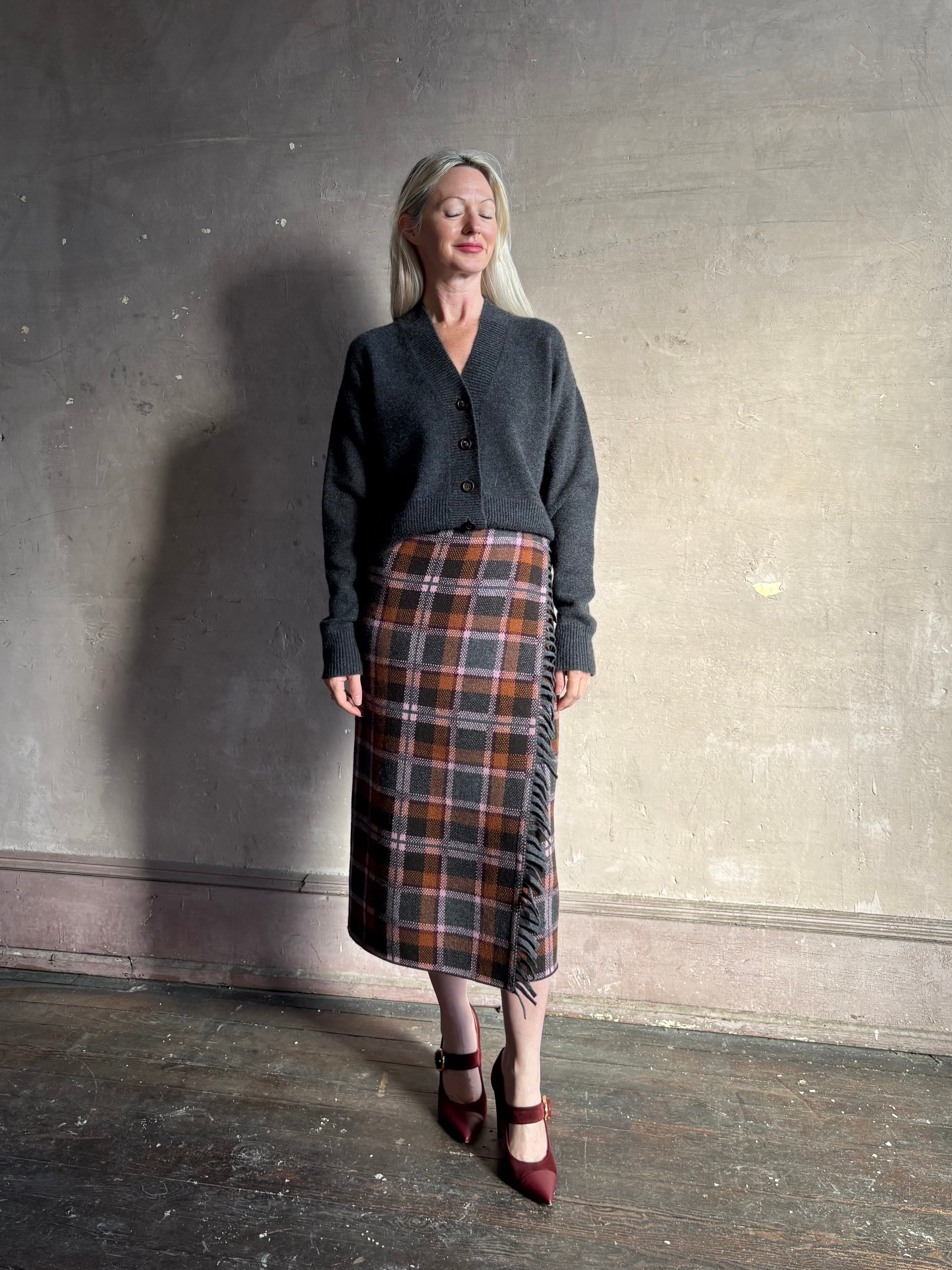 Mature woman wearing Guest in Residence Tartan Wrap Skirt in Sprinkle Combo wool-cashmere midi pencil silhouette and fringe trim