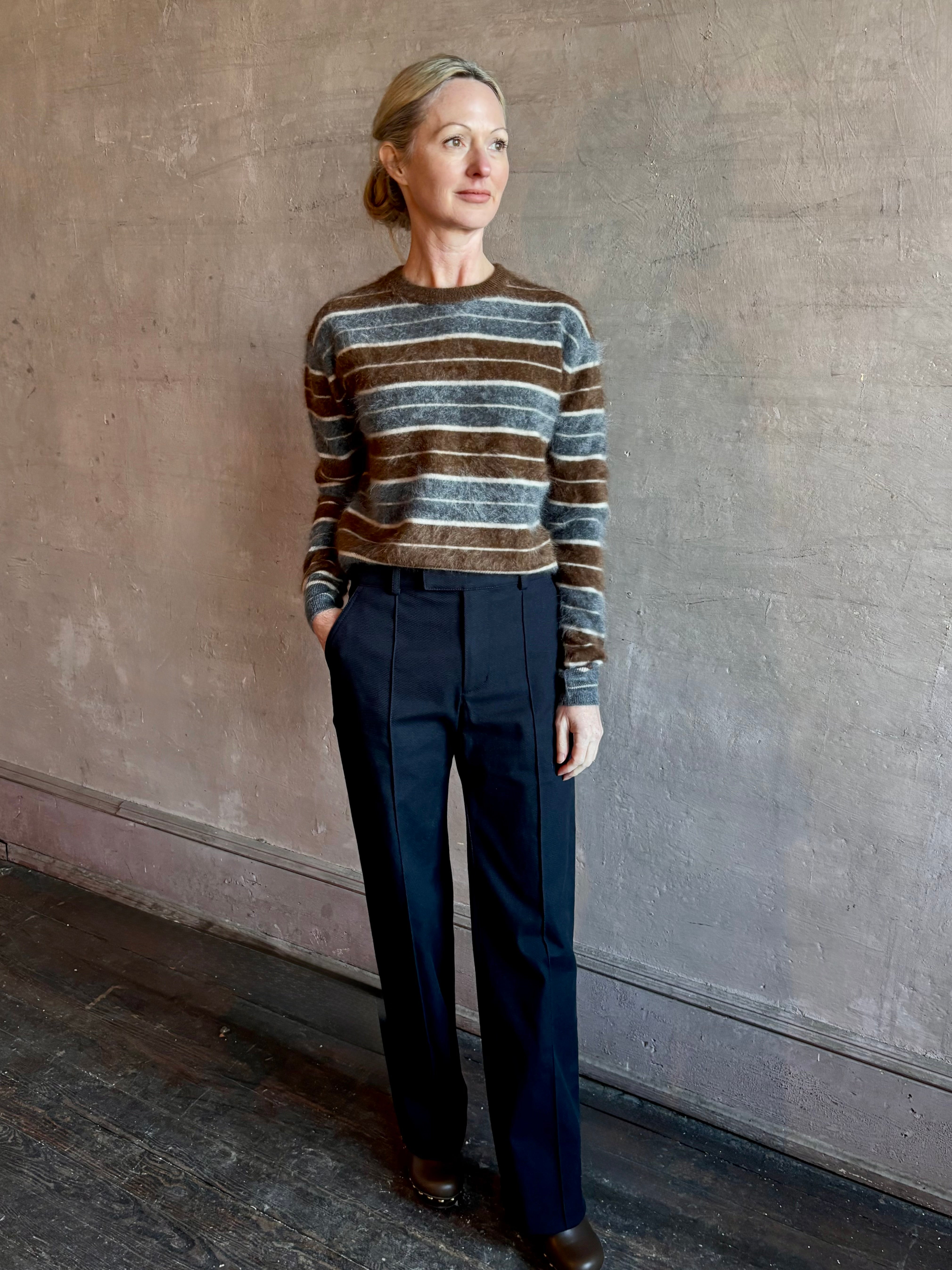 Image of woman wearing premium brushed cashmere crew neck sweater from Guest in Residence in brown and charcoal grey stripe 