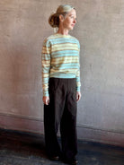 Image of woman wearing premium brushed cashmere crew neck sweater from Guest in Residence in sea glass and yellow stripe 