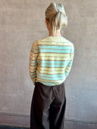 Image of woman wearing premium brushed cashmere crew neck sweater from Guest in Residence in sea glass and yellow stripe 