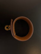 Hermès Kelly Twist Bracelet Brown & Yellow Gold: swift leather gold-plated Kelly turn-lock hardware hand assembled in France Pristine never-worn collector icon