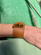 Hermès Kelly Twist Bracelet Brown & Yellow Gold: swift leather gold-plated Kelly turn-lock hardware hand assembled in France Pristine never-worn collector icon