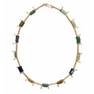 A bronze necklace featuring interspersed Byzantine glass beads in various shades of green, blue, and brown, with sand cast bronze metal accents handmade in USA by Texas jewelry artist Julie Cohn