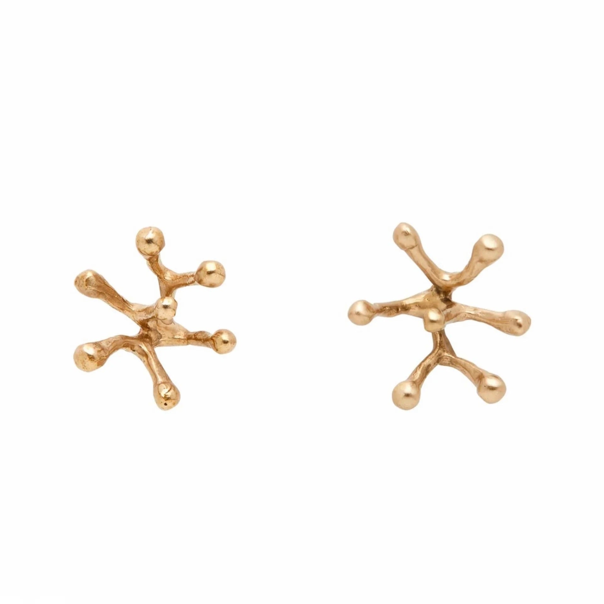 This image displays a pair of bronze Stamen earrings, featuring a unique gold-filled post and a detailed design inspired by natural leaf forms. Each earring is crafted to capture intricate textures and angles, showcasing a blend of bronze and gold tones that highlight their artisanal quality.