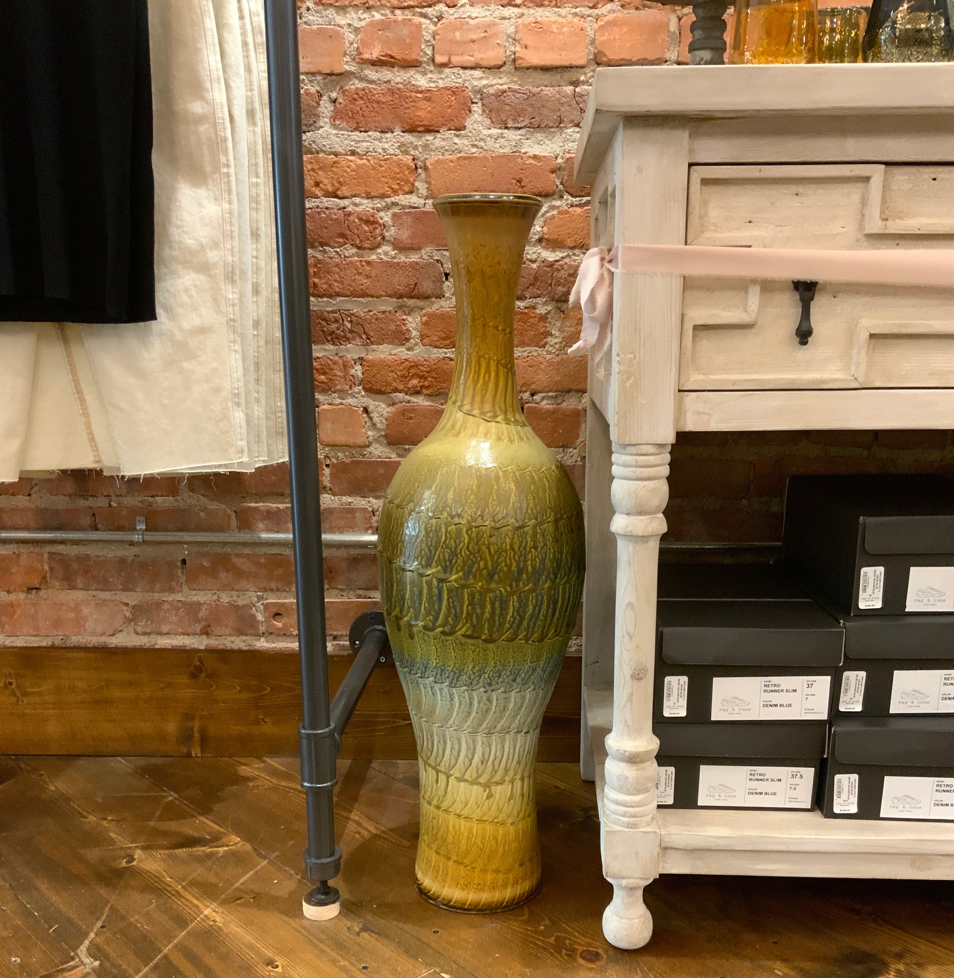 Image featuring North Carolina artist Joey Sheehan wood fired pottery tall vase sculpture.