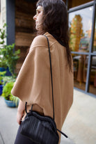Model wearing beige Kujten luxury french cashmere Asi cape with Mansur Gavriel pleated leather bag