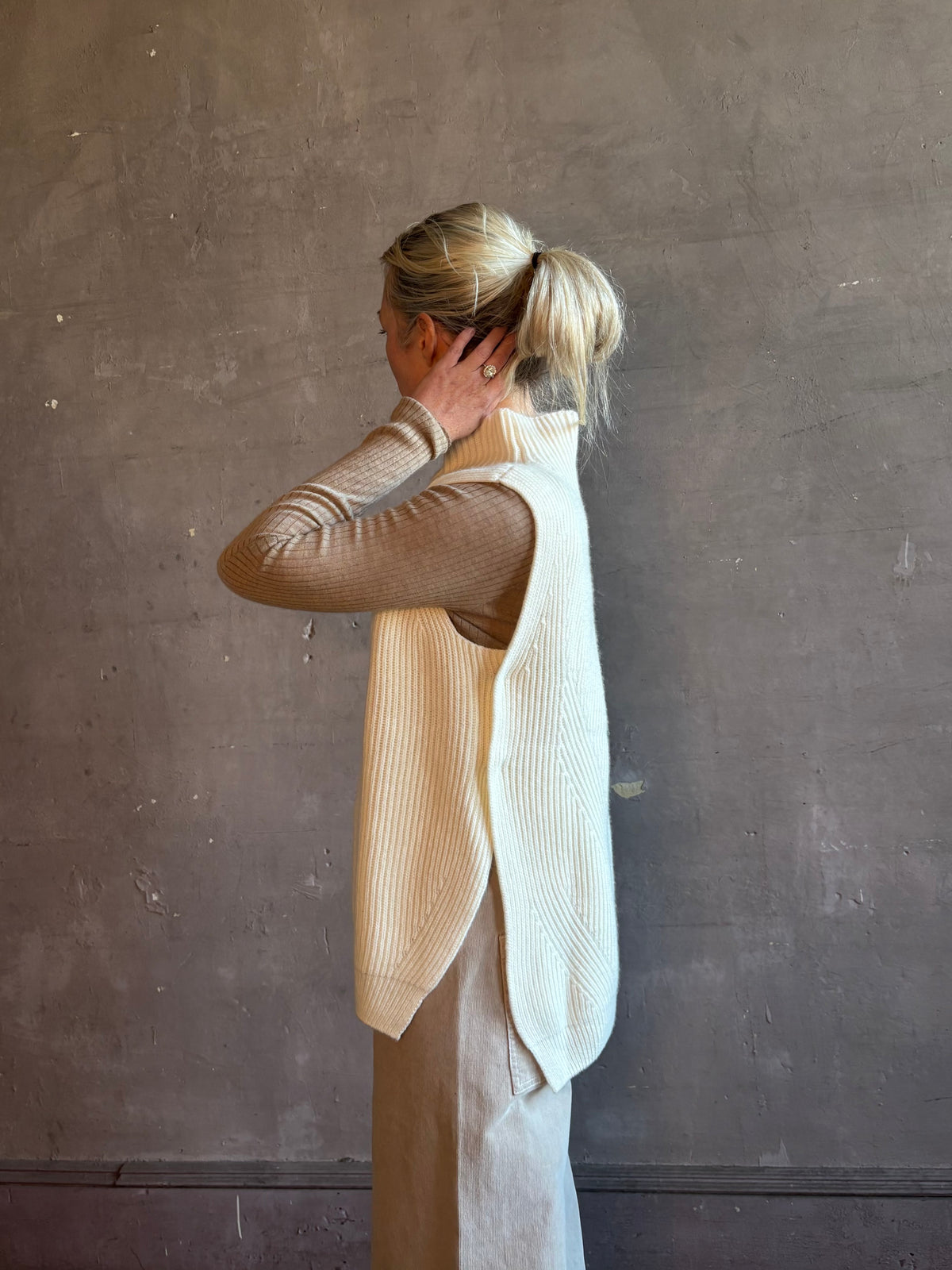 Mature woman wearing Kujten's Erika Funnel Neck Sweater Off White layering piece side snap closure 