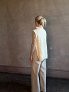 Mature woman wearing Kujten's Erika Funnel Neck Sweater Off White layering piece Mongolian cashmere 6-threads cardigan stitch modern design Parisian luxury