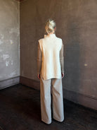 Mature woman wearing Kujten's Erika Funnel Neck Sweater Off White layering piece Mongolian cashmere 6-threads cardigan stitch modern design Parisian luxury