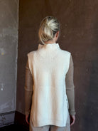 Mature woman wearing Kujten's Erika Funnel Neck Sweater Off White layering piece Mongolian cashmere 6-threads cardigan stitch modern design Parisian luxury