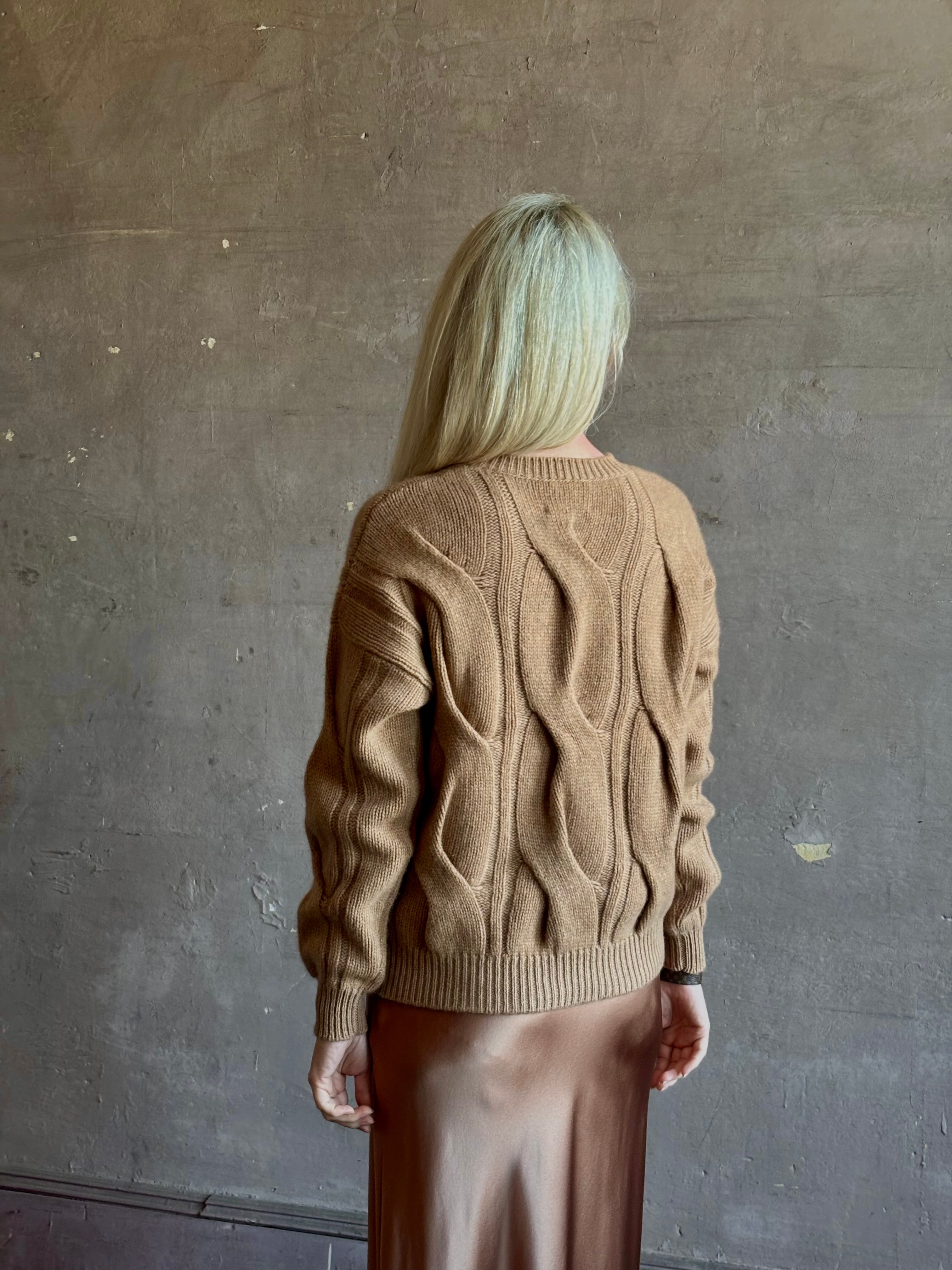 Mature woman wearing Kujten's Nils Cashmere Sweater Camelo Brown  timeless sculptural textured cable knit Parisian luxury