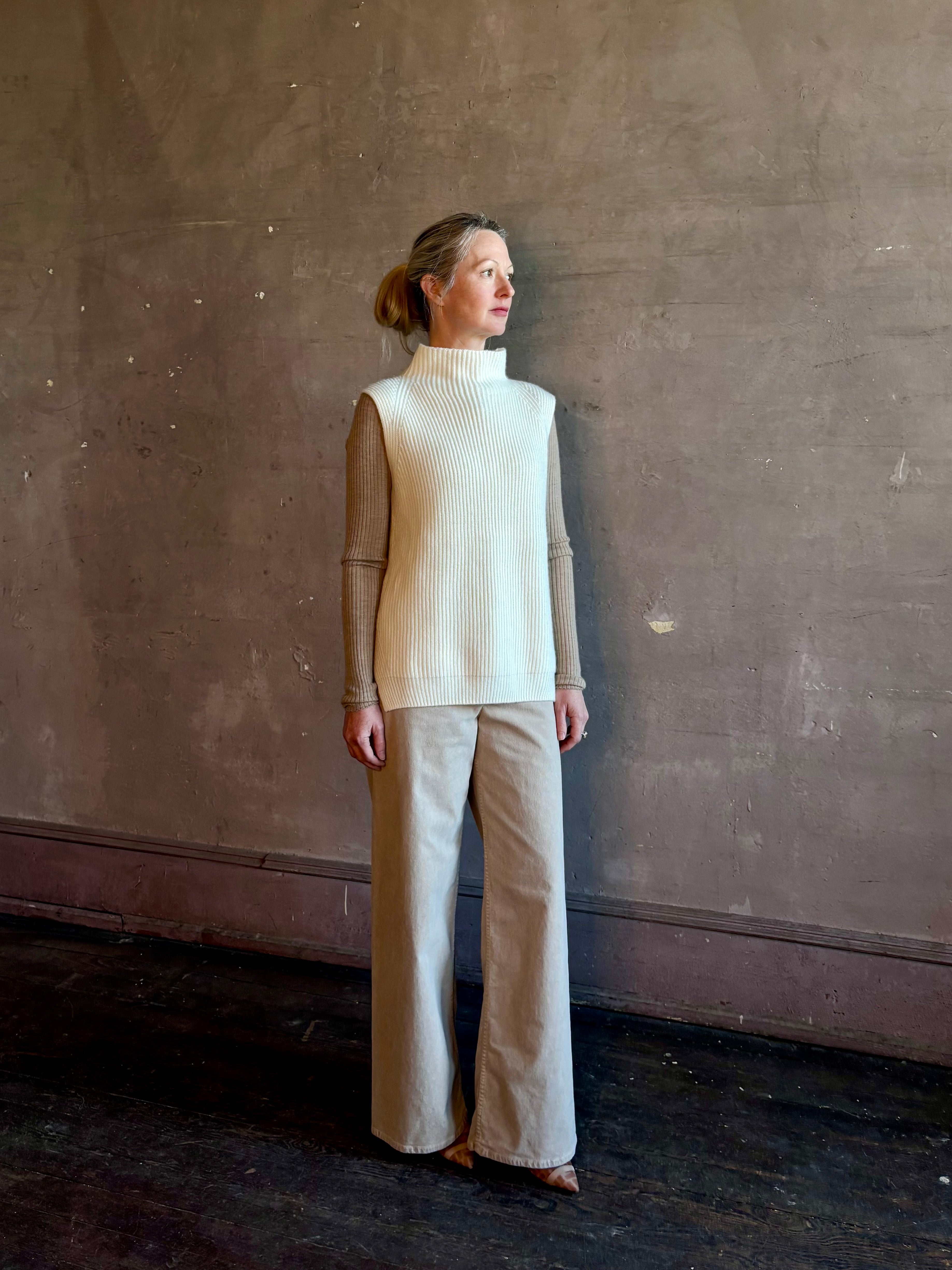 Mature woman wearing Kujten's Erika Funnel Neck Sweater Off White intricate modern design elegant Parisian luxury layering