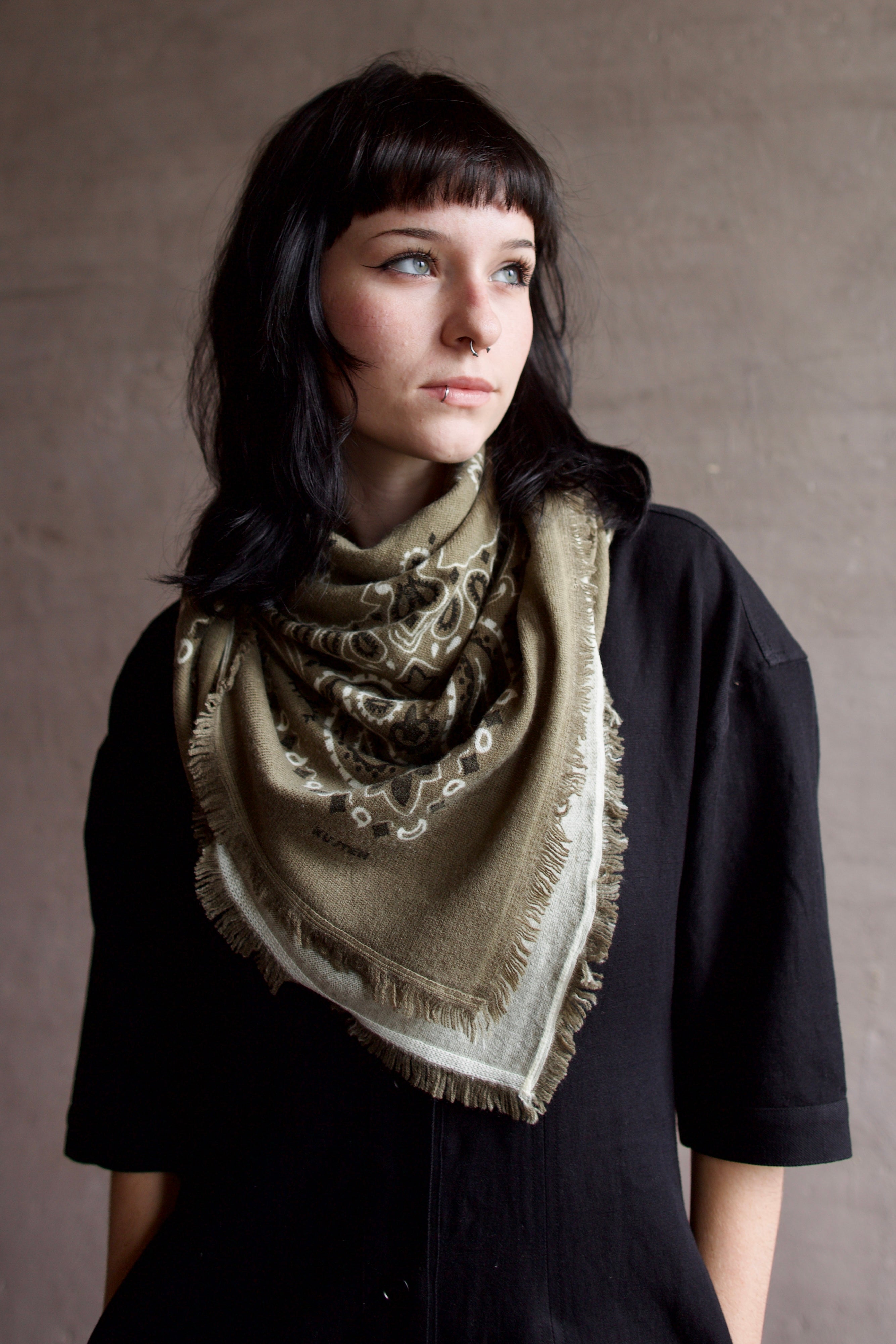 Image of model wearing luxury brand Kujten large  cashmere printed bandana in green colorway