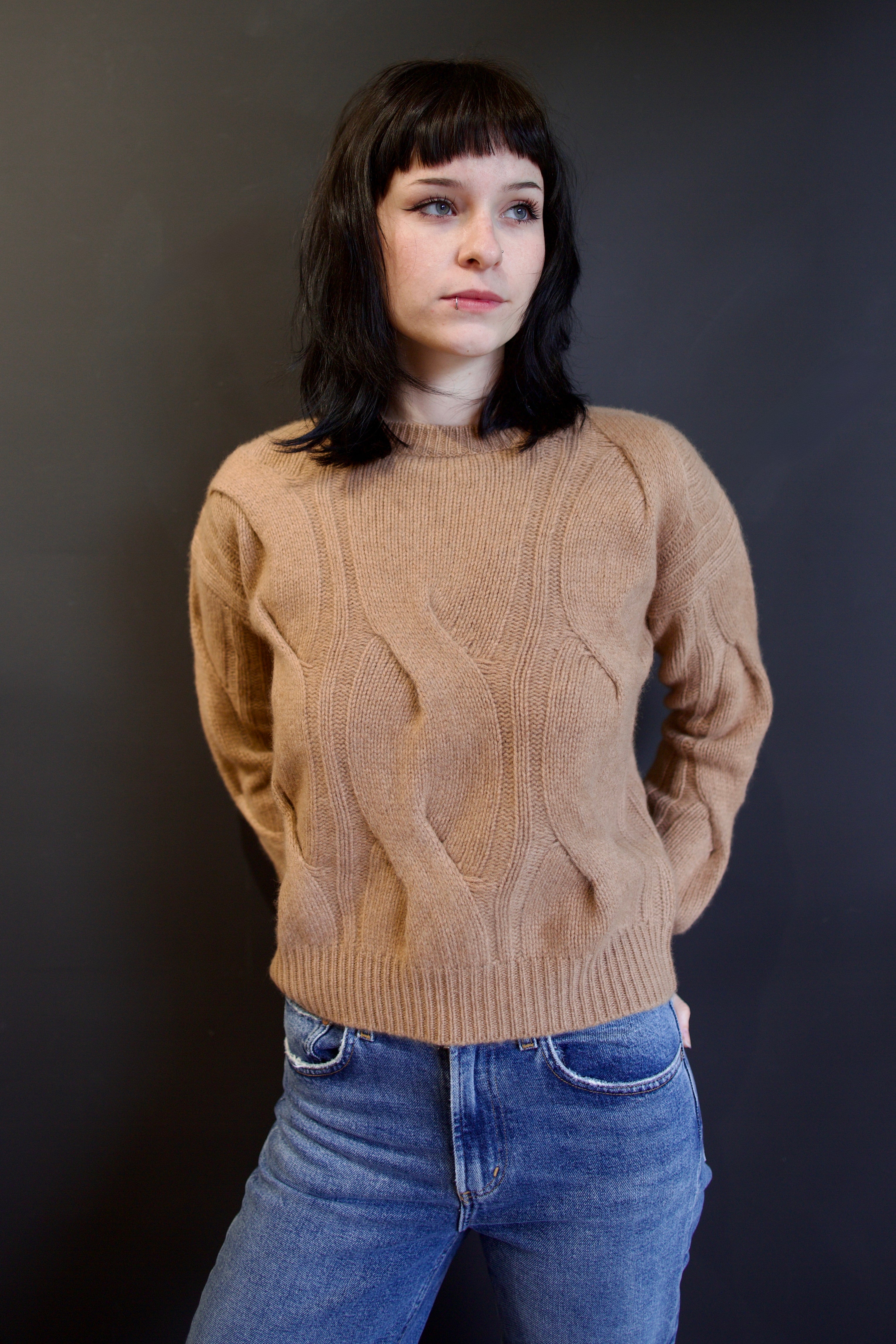 Model wearing luxury cashmere brand Kujten Nils camelo sweater with beautiful woven textural interest