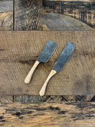 A rustic handcrafted charcuterie serving knife set with a hand forged steel blade and  wooden maple handle crafted in USA