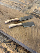 A rustic handcrafted charcuterie serving knife with a hand forged steel blade and  wooden maple handle made in USA