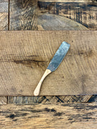 A rustic handcrafted charcuterie serving knife with a hand forged steel blade and  wooden maple handle made in USA