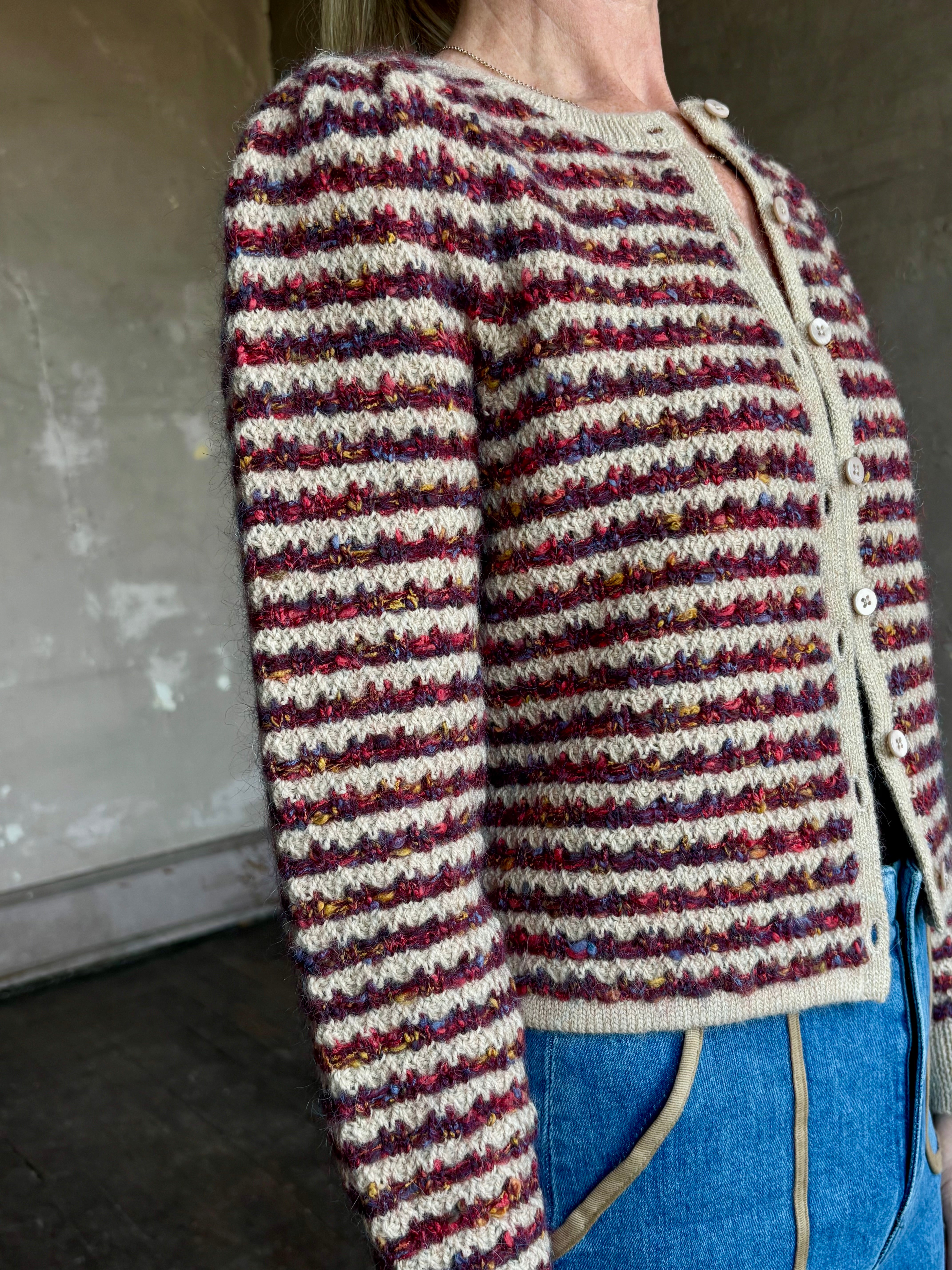 Image of woman wearing an elevated basic Le Jean Jasmine button up long sleeve alpaca blend cardigan sweater with burgundy and khaki stripe 