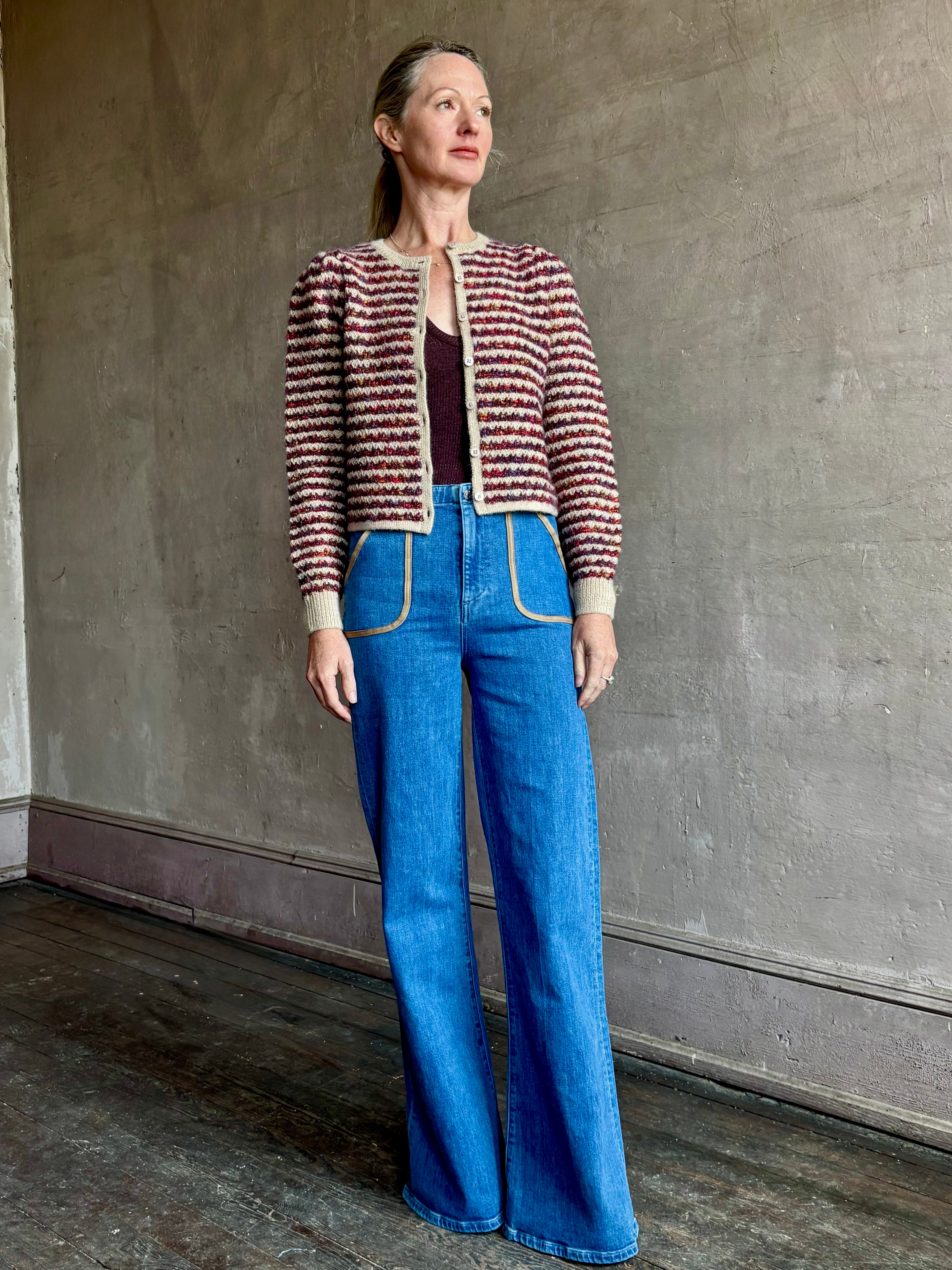 Image of a woman wearing Le Jean Joni flare high rise denim with outlined front pockets in contrasting fabric with a classic retro flare