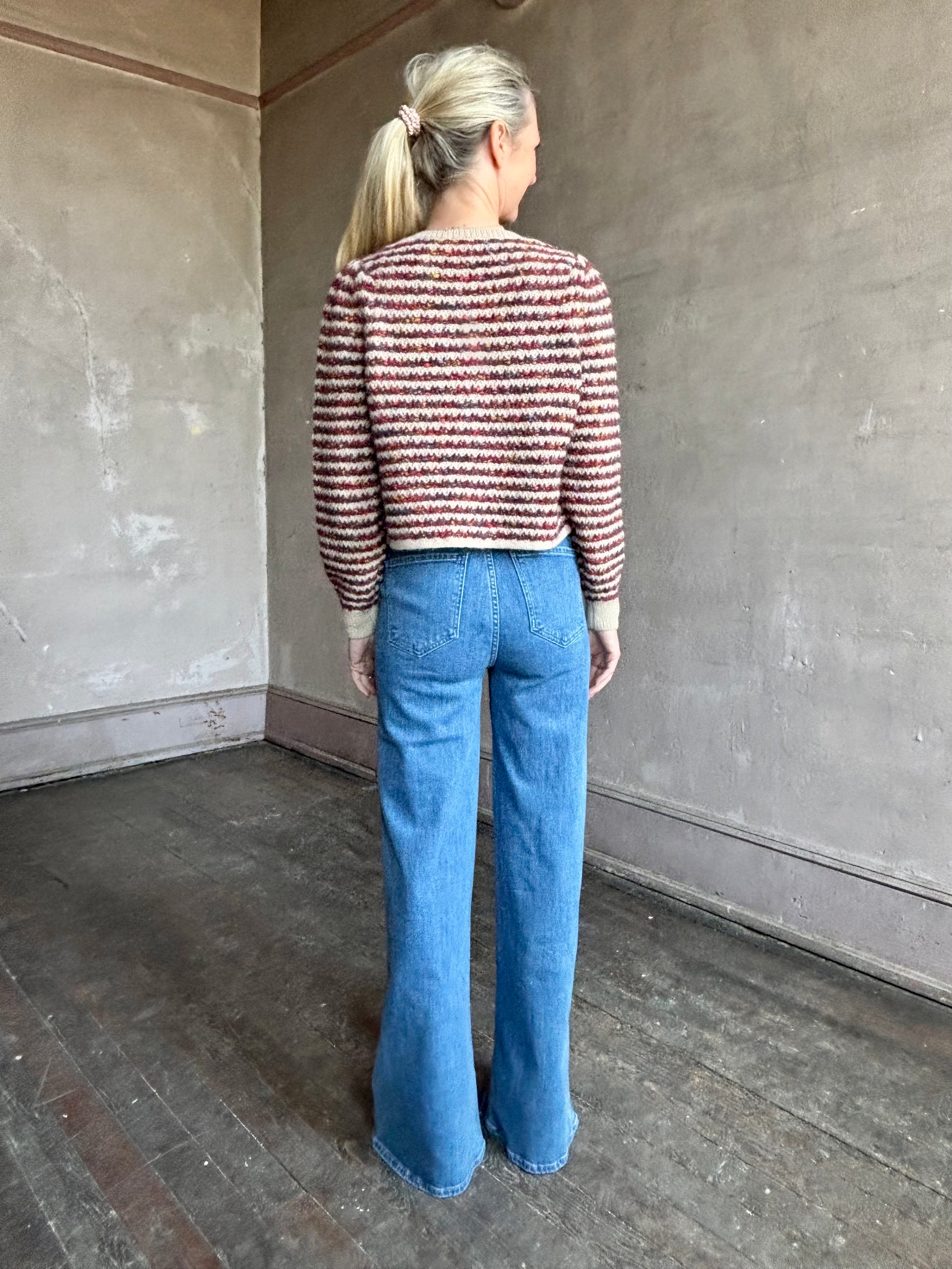 Image of a woman wearing Le Jean Joni flare high rise denim with outlined front pockets in contrasting fabric with a classic retro flare