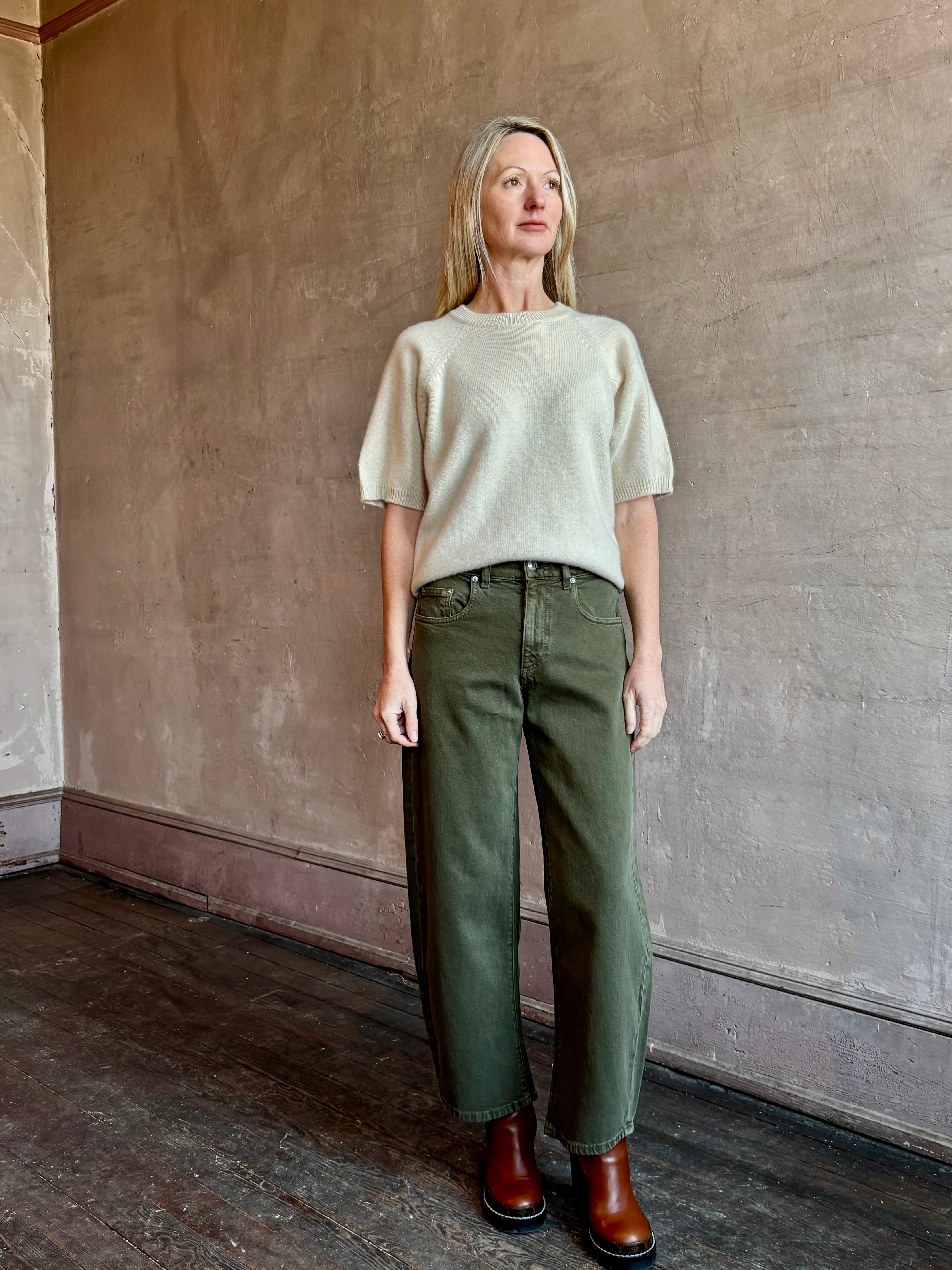 Image of mature woman wearing American Made Le Jean Nomad barrel denim in green color