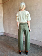 Image of mature woman wearing American made barrel leg cotton denim Le Jean Nomad in green wash 