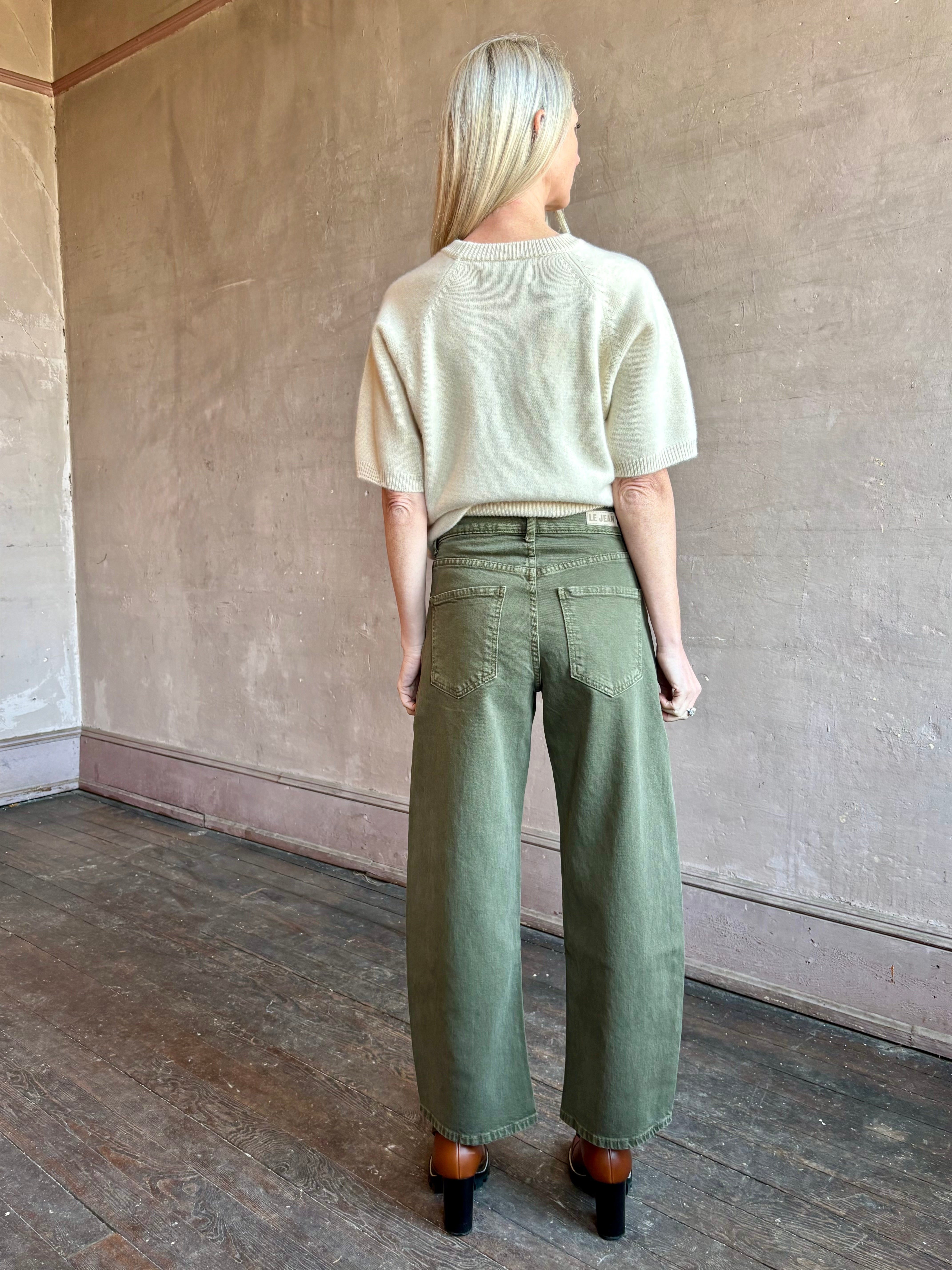 Image of mature woman wearing American made barrel leg cotton denim Le Jean Nomad in green wash 