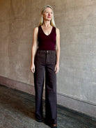 Image of mature woman wearing American made LE JEAN Virginia Wide Leg premium cotton denim in chocolate brown with front patch pockets