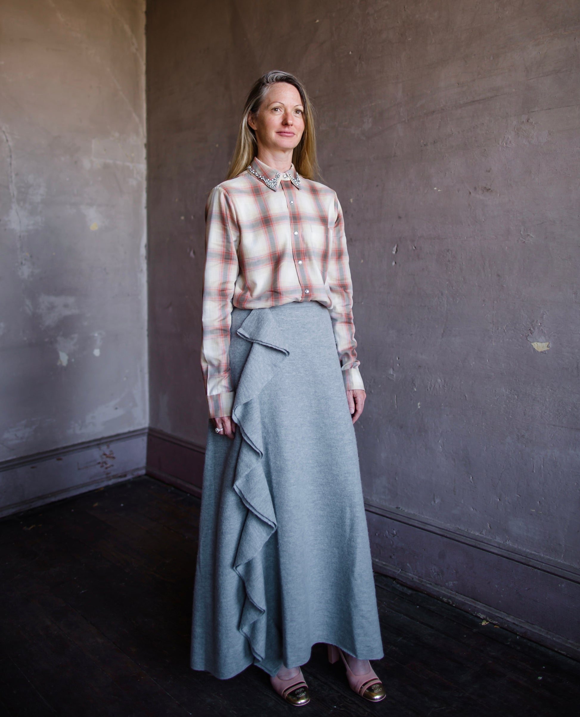 Image featuring a woman wearing le superbe grandpa brown plaid shirt with ulla johnson wool ruffle skirt