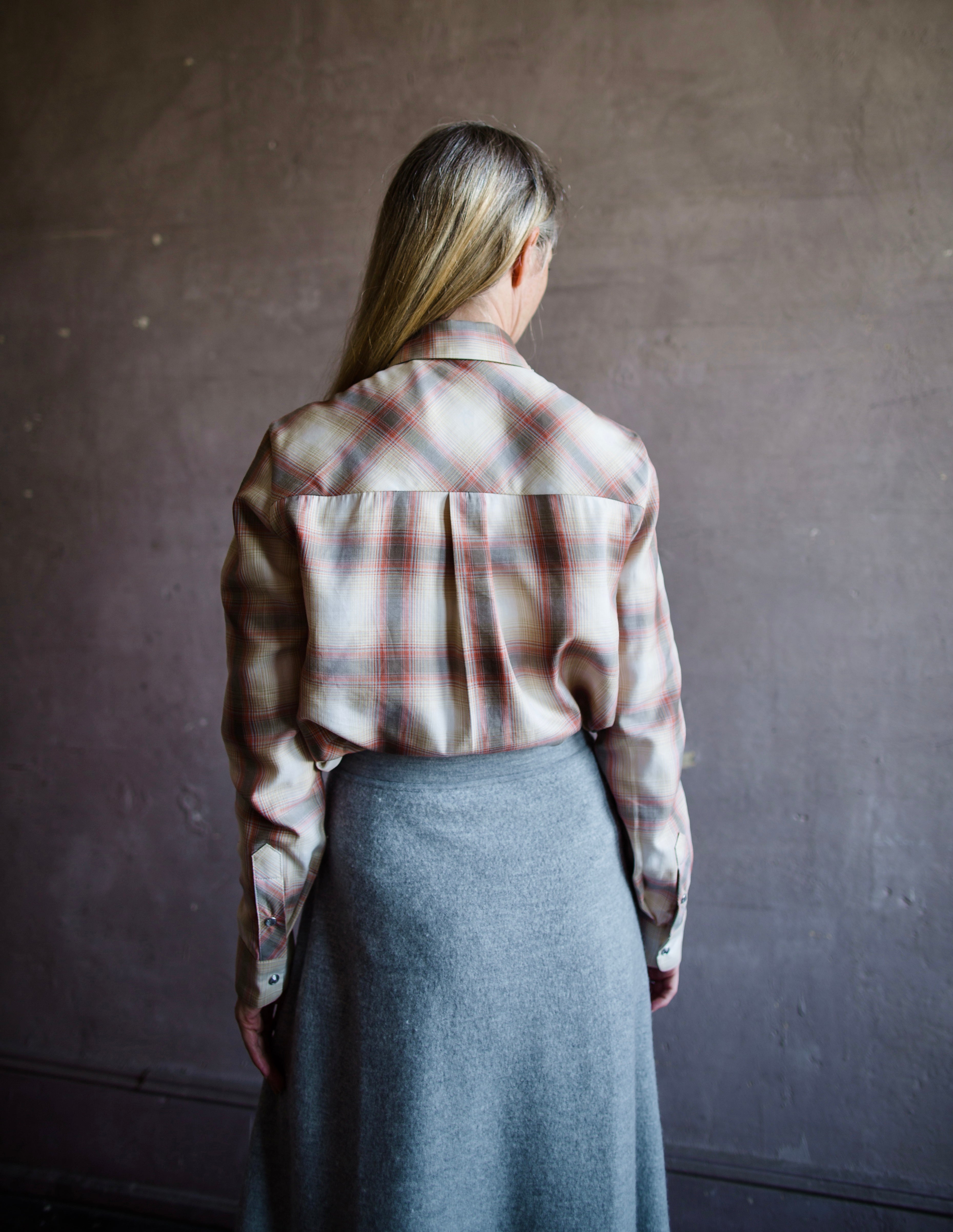 Image of a woman wearing the fancy grandad shirt by Le Superbe featuring snap crystal button closure with embellishment on the collar