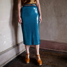 Image featuring a woman wearing the Le Superbe blue sequin midi skirt with stretchy fabric for ease of movement.