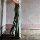 Image featuring a woman wearing the cotton Le Superbe werk pant with full length wide leg, high waist and side slant pockets in green.