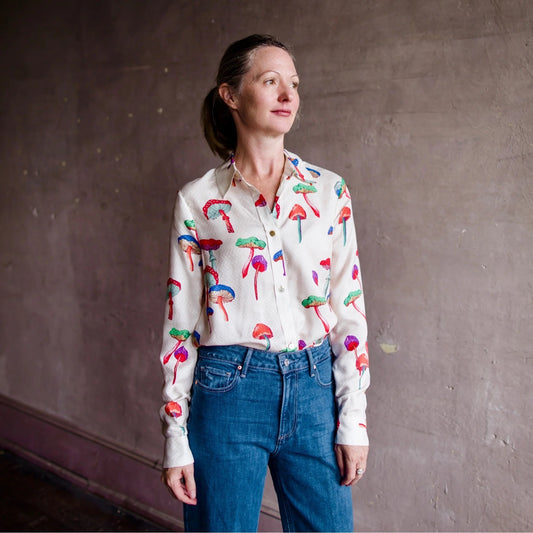 Image of a woman wearing the Le Superbe micro magic Ex BF shirt in a mushroom print button down with long sleeves, button cuffs and placket.