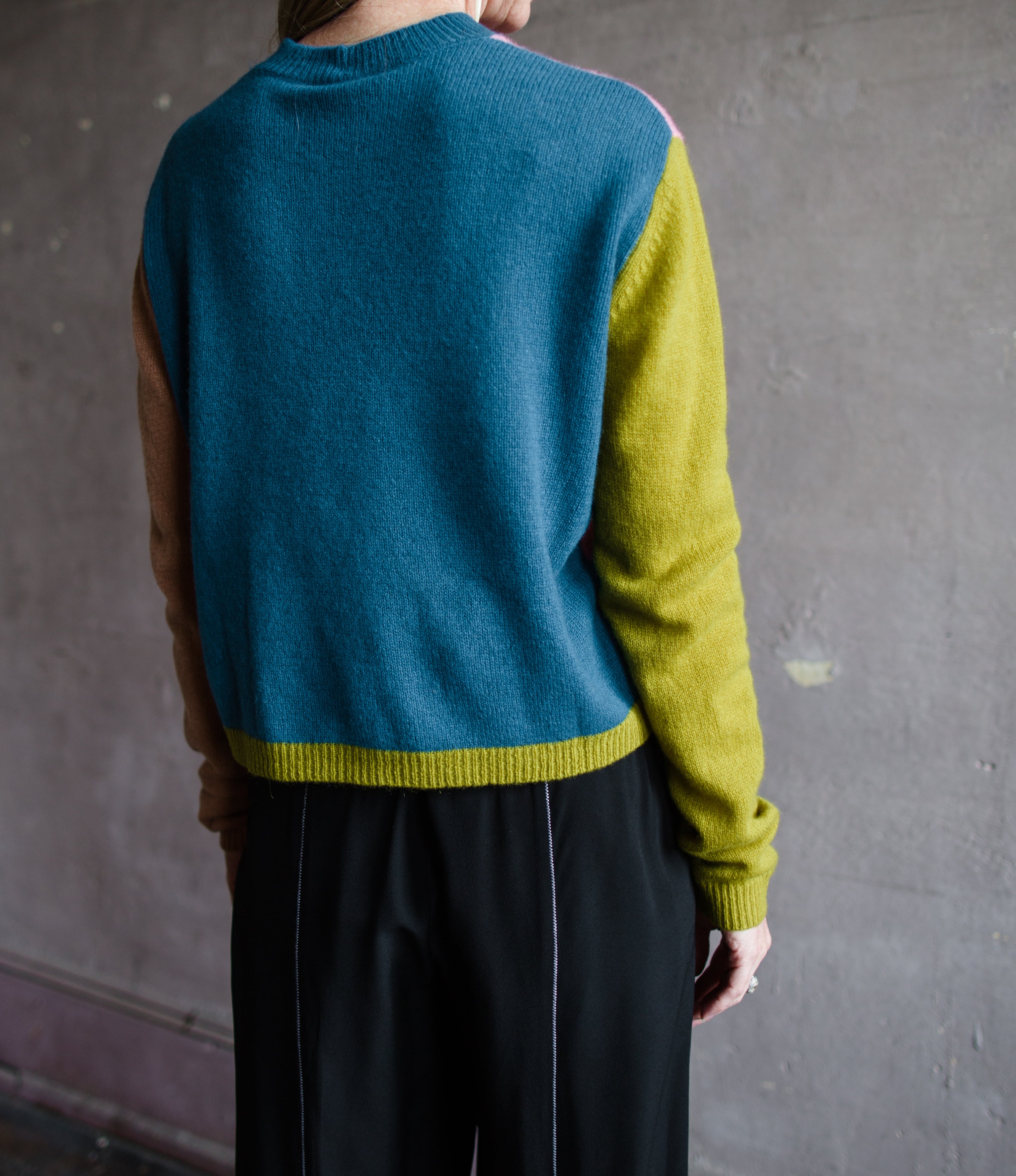 Close up image of a woman wearing the mondrian cashmere sweater by Le Superbe with a crew neckline, drop shoulders and a slightly relaxed fit.