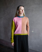 Image featuring a woman wearing the mondrian cashmere sweater by Le Superbe with a crew neckline with drop shoulders and a slightly relaxed fit.