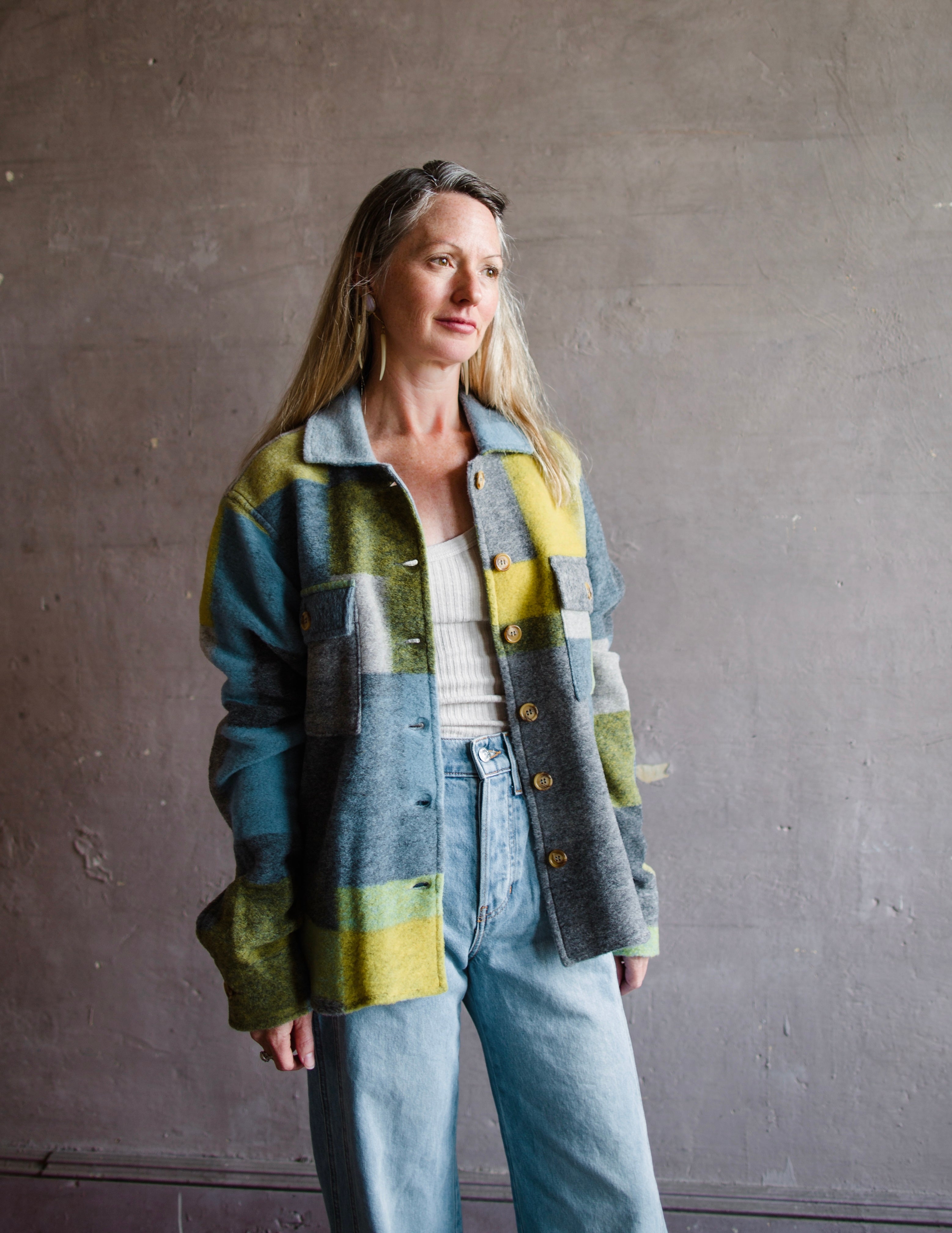 Image featuring a woman wearing the nirvana pendleton jacket by Le Superbe features a button front with flap pockets and a boxy fit.