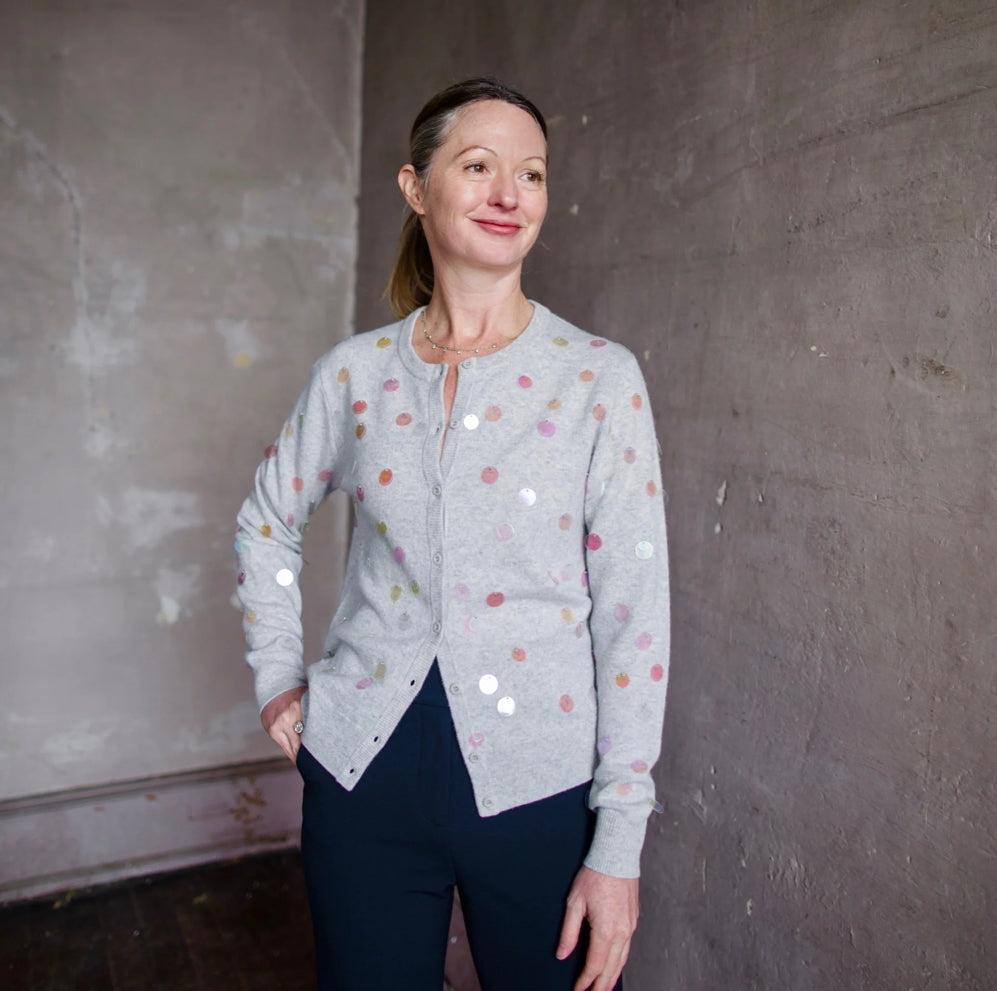 Image featuring a woman wearing the Lingua Franca Starla Grey cashmere Cardigan with iridescent sequin embellishments.