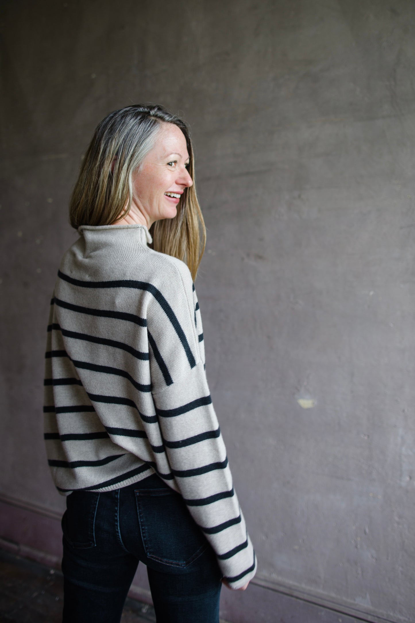 Image featuring a woman wearing the Sandy striped sweater by Lisa Yang with a high neckline and relaxed, boxy fit and 100% organic cashmere.