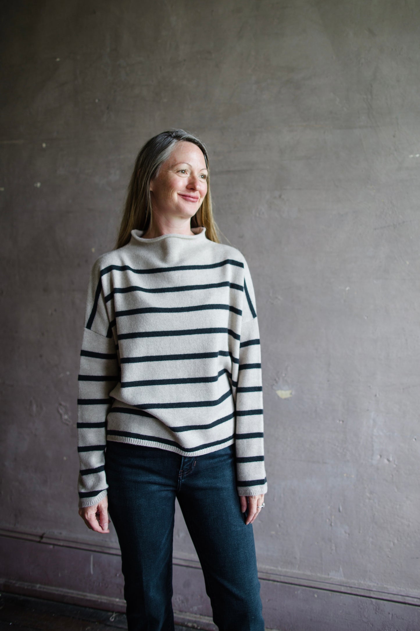 Image featuring a woman wearing the Sandy striped sweater by Lisa Yang with a high neckline and relaxed, boxy fit and 100% organic cashmere.