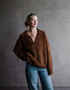 Image of a woman wearing the Kerry sweater by Lisa Yang with a v neckline and relaxed fit in the softest tamarind brown brushed cashmere.