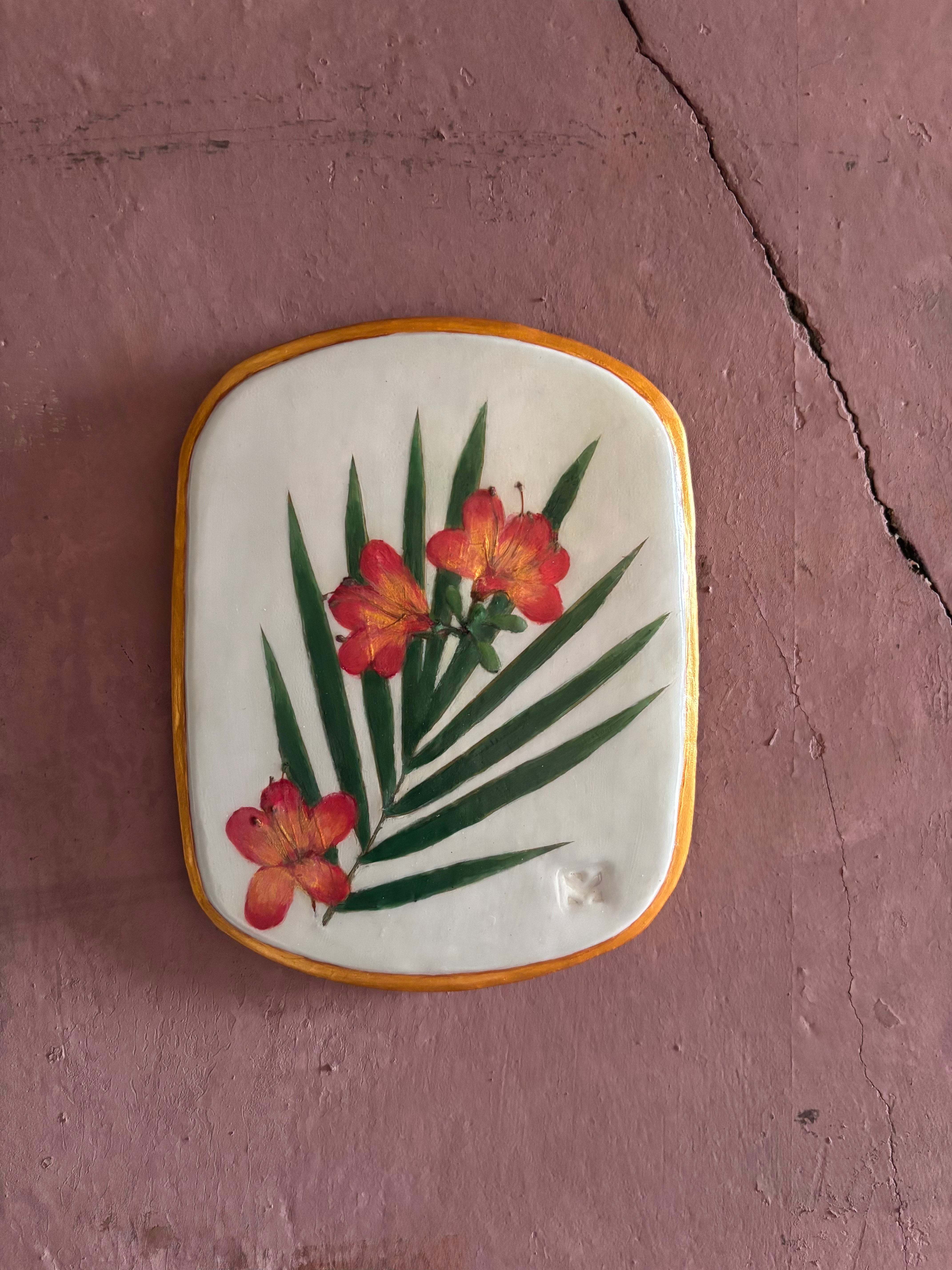 A rectangular ceramic tile featuring botanical pressed azaleas with green palm leaves on white clay