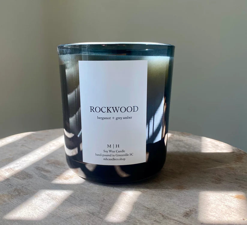 Image of the Southbourne candle  hand poured in Greenville South Carolina in a calming blend of bergamot and grey amber crafted in a glass container with Soy Wax and a wood wick