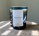 Image of the Southbourne candle  hand poured in Greenville South Carolina in a calming blend of bergamot and grey amber crafted in a glass container with Soy Wax and a wood wick
