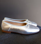 Image featuring the Dream Ballerina Flats by Mansur Gavriel with a small bow with a round toe and flat heel in matte silver.