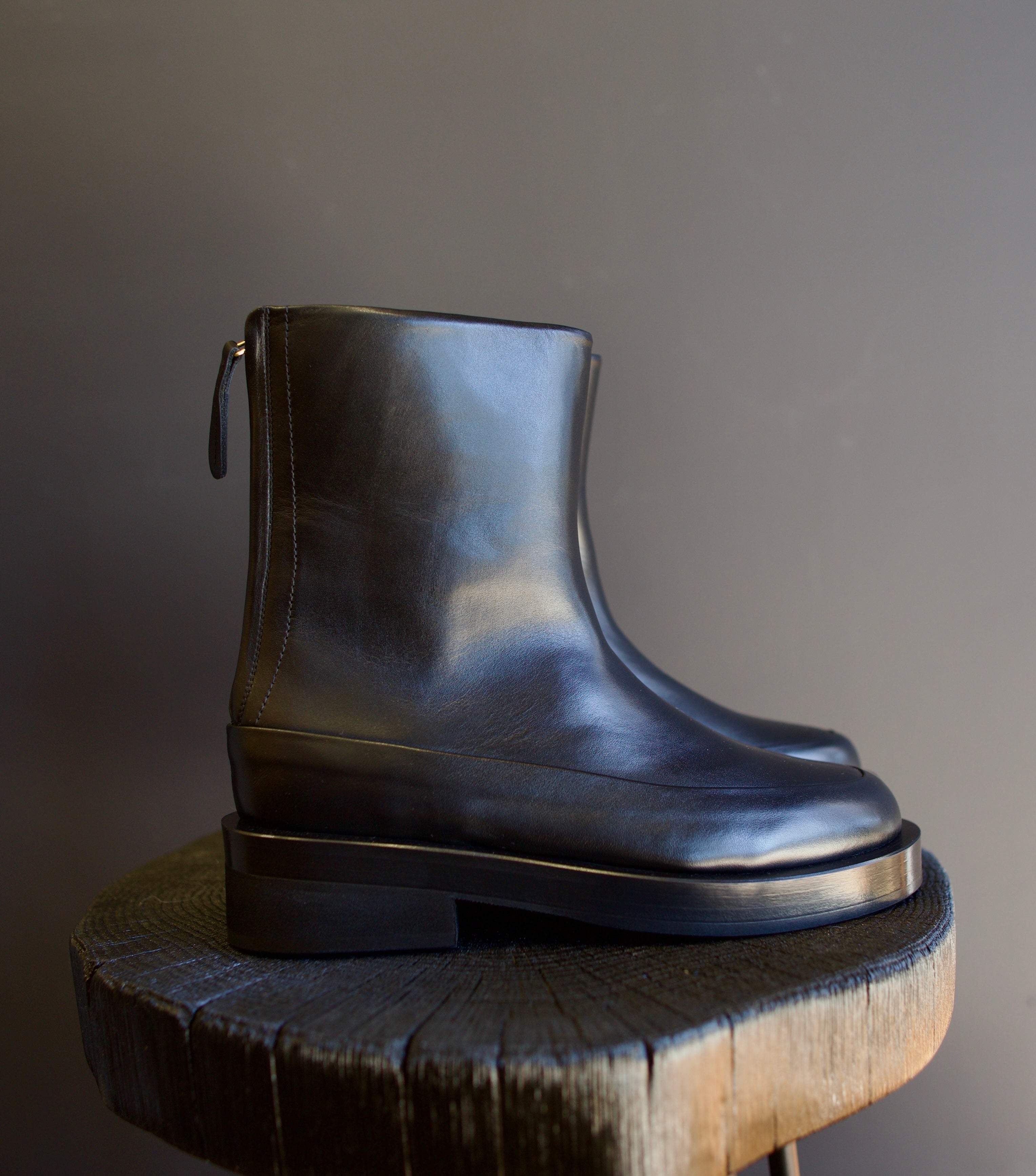 Image featuring The Marion Boot by Mansur Gavriel in black with a round toe, back zip closure and a chunky sole.