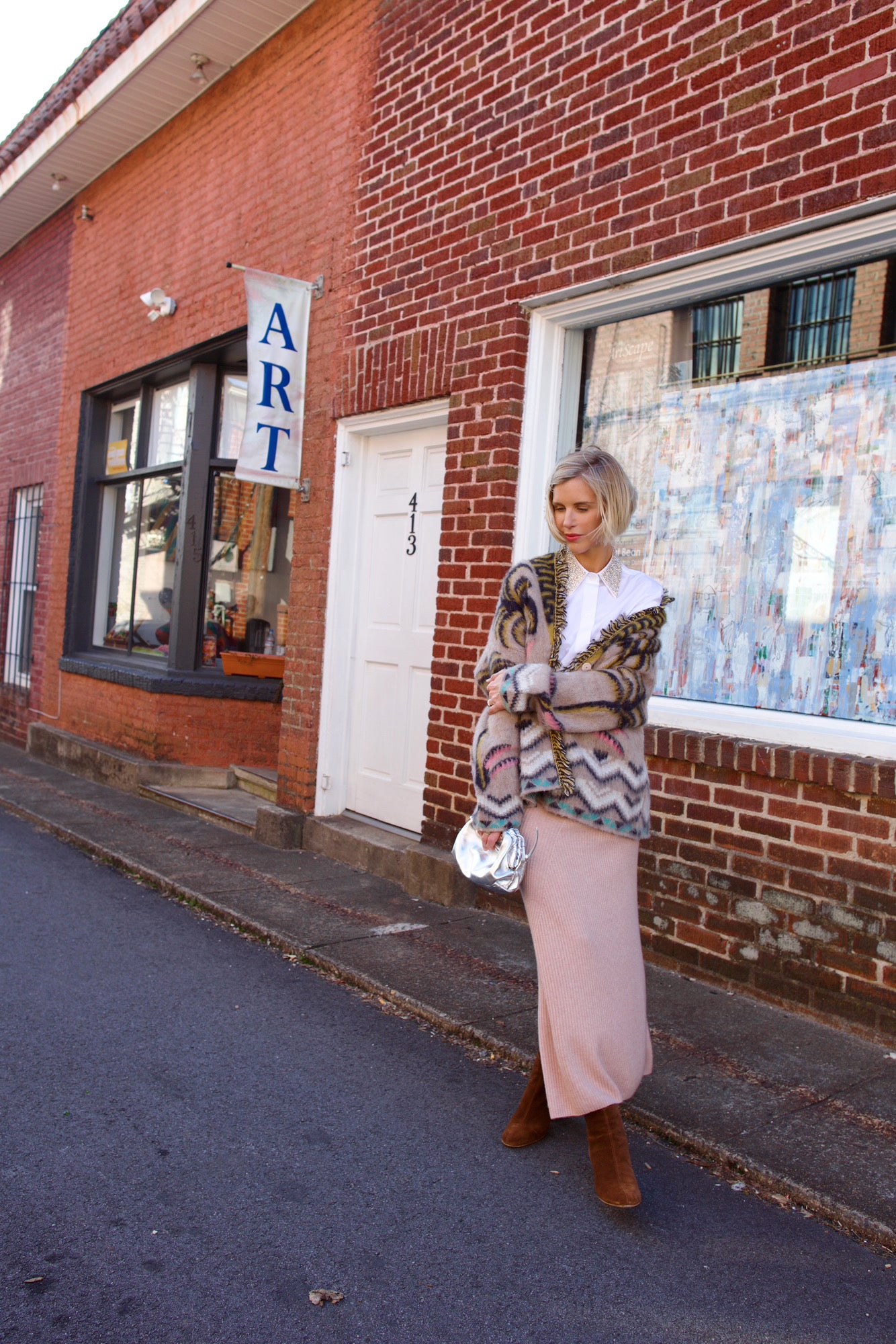 Mature woman wearing Naadam's Ribbed Maxi Wool and Cashmere blend knit Skirt in Blush elastic waistband modern ribbed texture